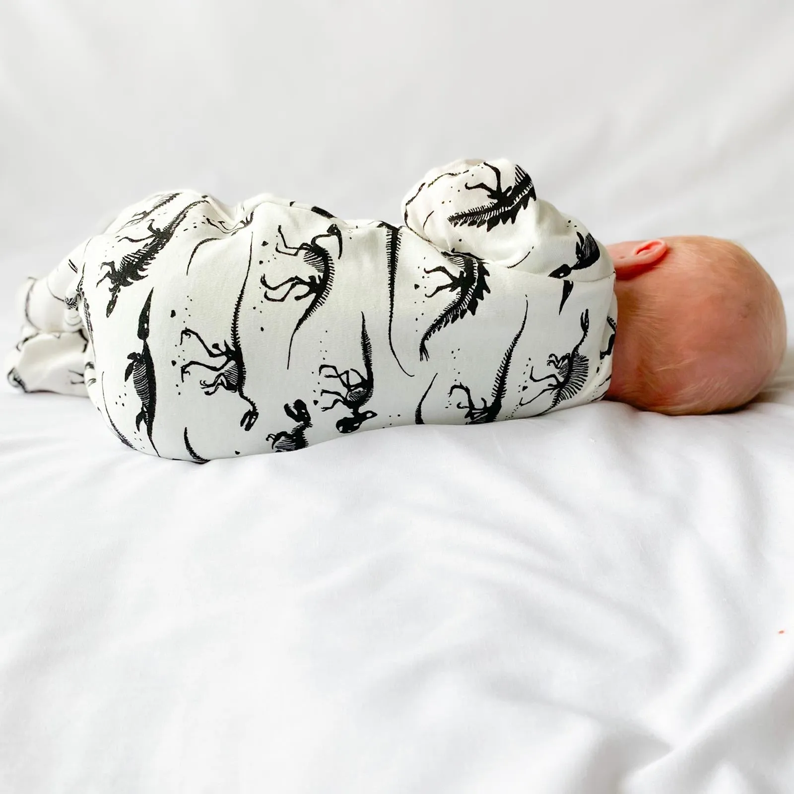 Milk Dino cotton sleepsuit